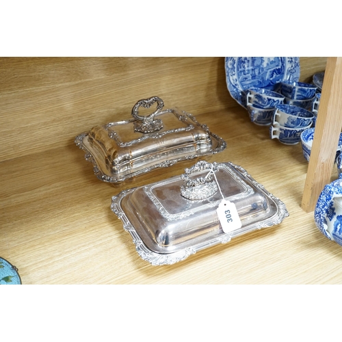 303 - Three plated entree dishes and covers and a pair of candlesticks, candlesticks 26cm high