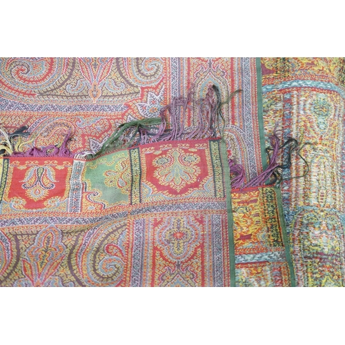 306 - A 19th century woven multi coloured wool and silk Paisley shawl,  with large all over paisley tear d... 