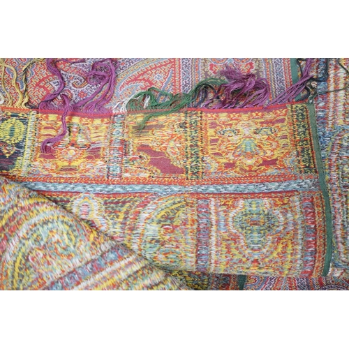 306 - A 19th century woven multi coloured wool and silk Paisley shawl,  with large all over paisley tear d... 