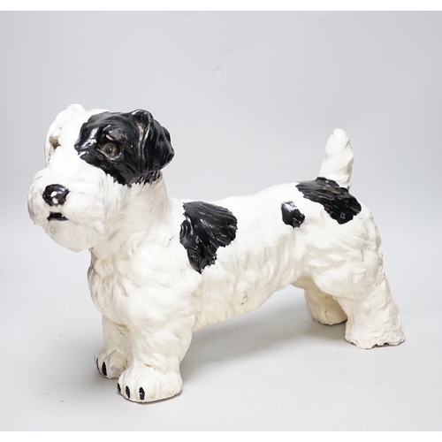 321 - A painted plaster model of a terrier dog, 28cm high, 41cm long