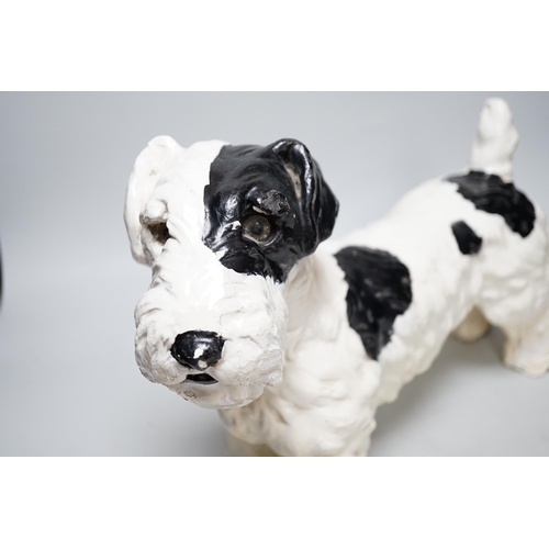 321 - A painted plaster model of a terrier dog, 28cm high, 41cm long