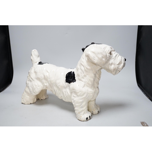 321 - A painted plaster model of a terrier dog, 28cm high, 41cm long