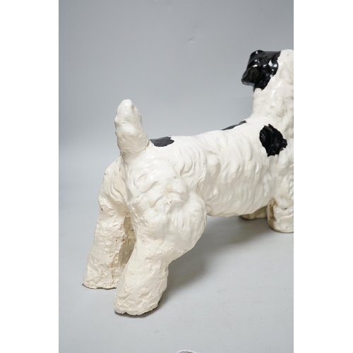 321 - A painted plaster model of a terrier dog, 28cm high, 41cm long