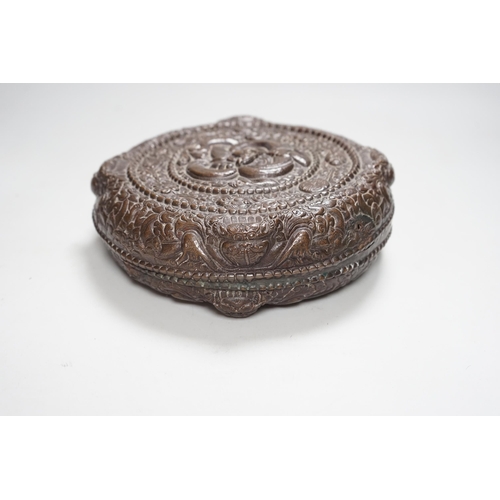 354 - A Tibetan repousse work copper box and cover, 19th century, 22cm