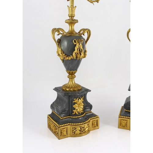 A pair of Louis XVI style ormolu and grey marble five light candelabra with  scrolling branches and u