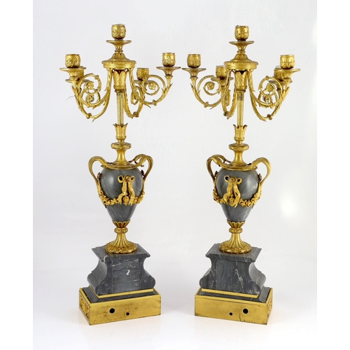 A pair of Louis XVI style ormolu and grey marble five light candelabra with  scrolling branches and u