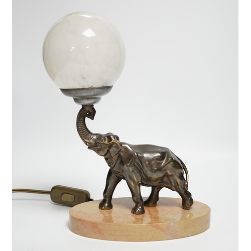 An Art Deco spelter elephant table lamp with glass globe