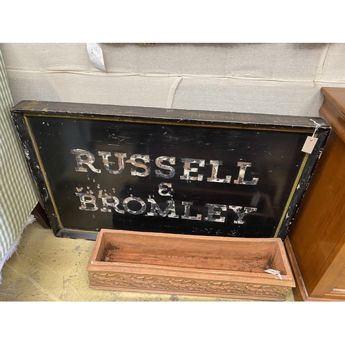 11 - A vintage rectangular painted 'Russell & Bromley' advertising sign, length 123cm, height 78cm