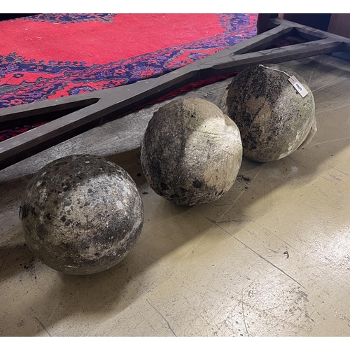 16 - A trio of graduated reconstituted weathered stone ball finials, largest height 37cm