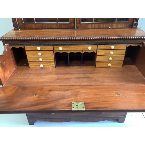 18 - A Regency mahogany secretaire bookcase, the interior with turned ivory handles, width 106cm, depth 5... 