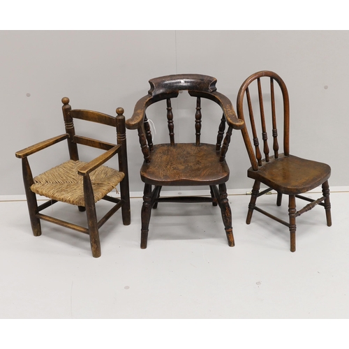 29 - A child's Victorian elm and beech bow chair, a single chair and a rush seat chair