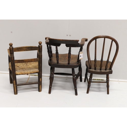 29 - A child's Victorian elm and beech bow chair, a single chair and a rush seat chair