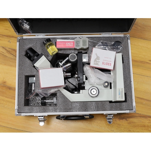 297 - A cased binocular Apex Researcher Compound Microscope with a selection of accessories, slides, Apex ... 