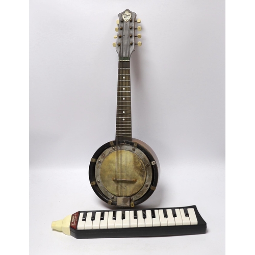 305 - A John Grey and sons, London eight string banjolele in original case and a Hohner melodica