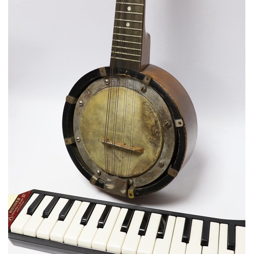 305 - A John Grey and sons, London eight string banjolele in original case and a Hohner melodica