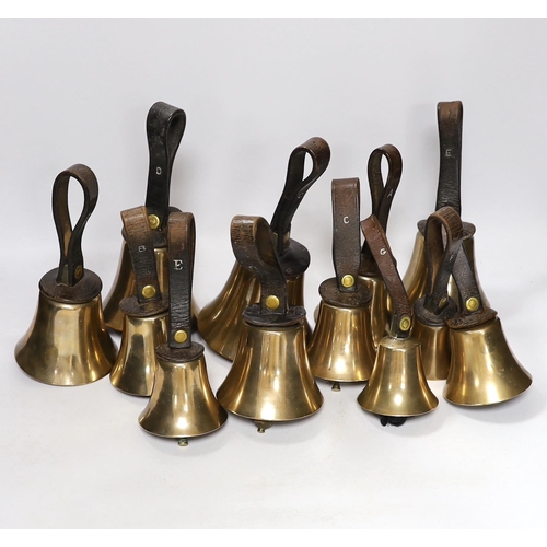 307 - A set of thirty two musical handbells, full chromatic scale, circa 1900, largest 23cm, including lea... 