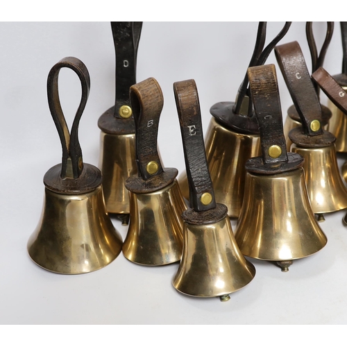 307 - A set of thirty two musical handbells, full chromatic scale, circa 1900, largest 23cm, including lea... 