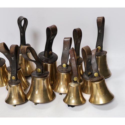 307 - A set of thirty two musical handbells, full chromatic scale, circa 1900, largest 23cm, including lea... 