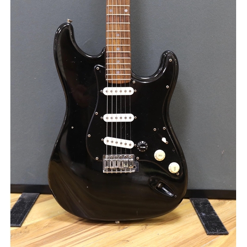 309 - A cased Squier Strat by Fender electric guitar with rosewood neck and balance lacquer body, together... 