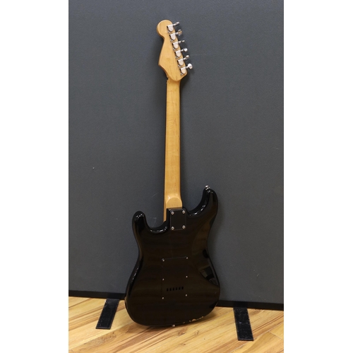 309 - A cased Squier Strat by Fender electric guitar with rosewood neck and balance lacquer body, together... 