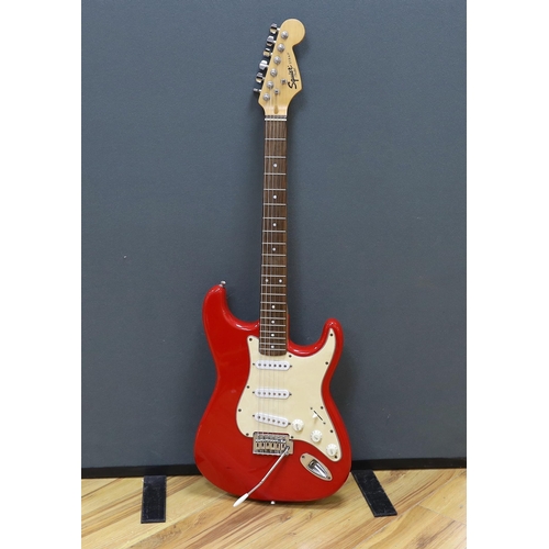 312 - A Squier Strat by Fender electric guitar with rosewood neck and red lacquer body