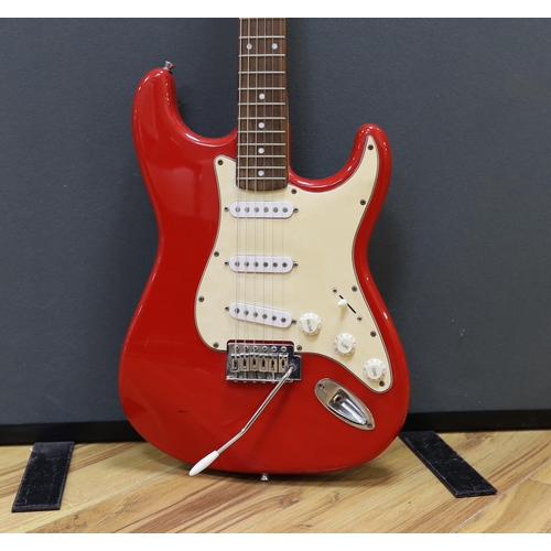 312 - A Squier Strat by Fender electric guitar with rosewood neck and red lacquer body