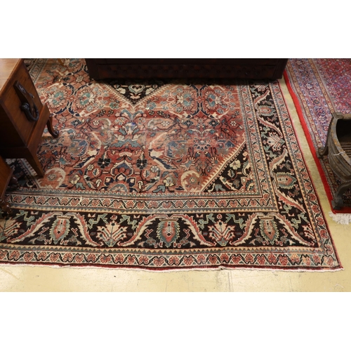 36 - A Heriz brick red ground carpet, 370 x 280cm