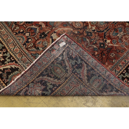 36 - A Heriz brick red ground carpet, 370 x 280cm