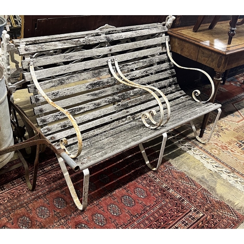 48 - A vintage wrought iron and weathered teak two-seater garden bench, length 121cm, height 82cm