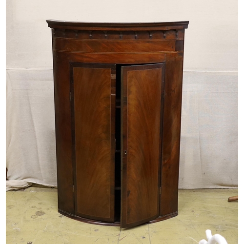 73 - A 19th century George III bow-fronted hanging mahogany corner cupboard, width 84cm, depth 59cm, heig... 