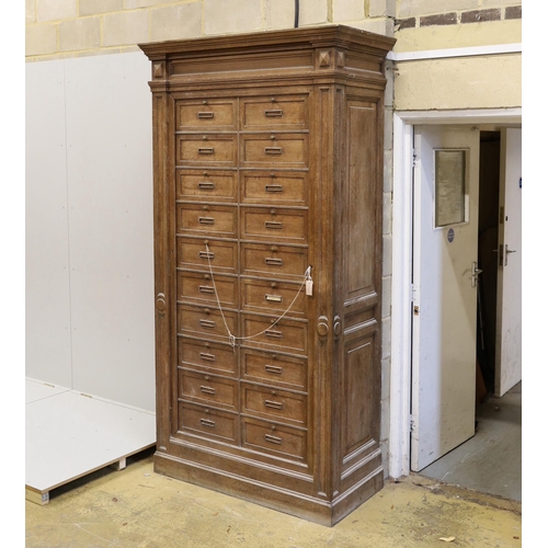 80 - An early 20th century French oak notaries cabinet with twenty fall front compartments, width 125cm, ... 