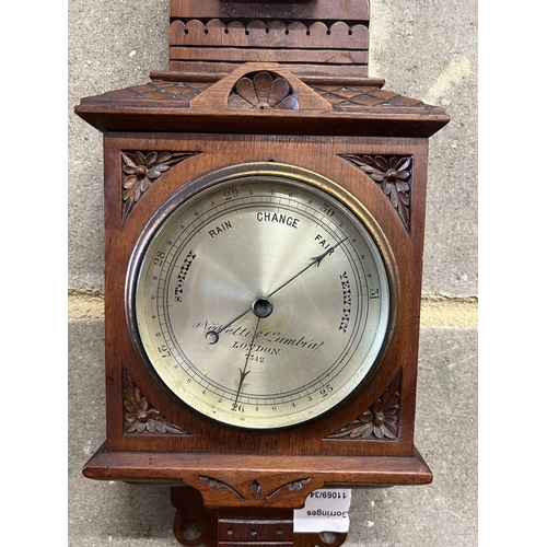 9 - A Victorian walnut cased aesthetic movement style aneroid barometer and thermometer, Negretti & Zamb... 