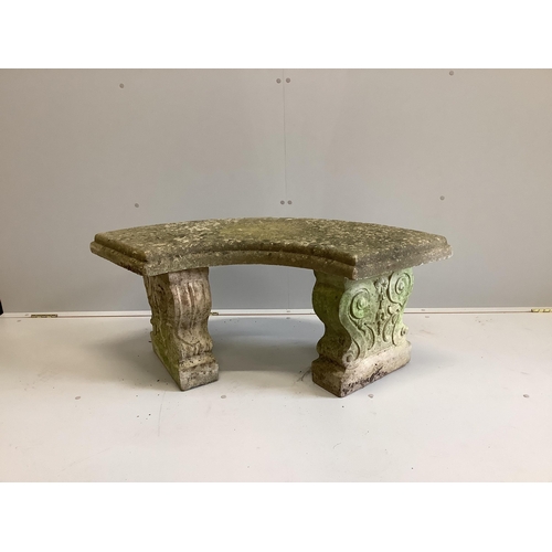 1003 - A weathered reconstituted stone curved garden bench, width 110cm, depth 48cm, height 45cm