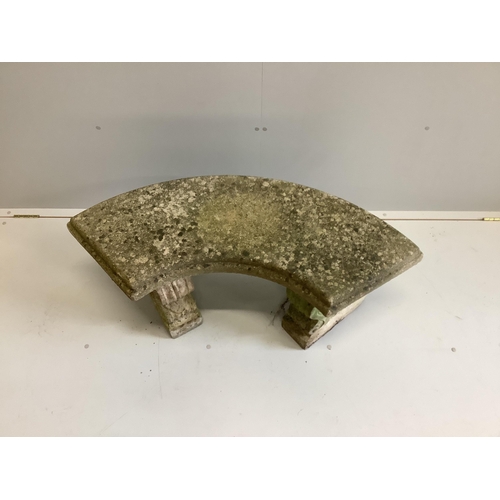 1003 - A weathered reconstituted stone curved garden bench, width 110cm, depth 48cm, height 45cm