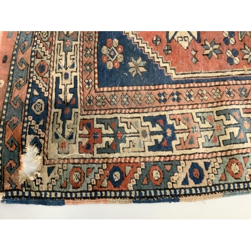 1045 - A Caucasian blue ground rug, 150 x 106cm