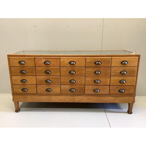 1054 - An early 20th century oak haberdashery cabinet, width 180cm, depth 58cm, height 91cm