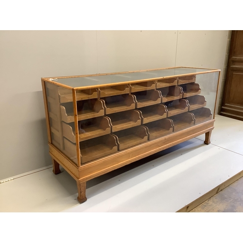 1054 - An early 20th century oak haberdashery cabinet, width 180cm, depth 58cm, height 91cm