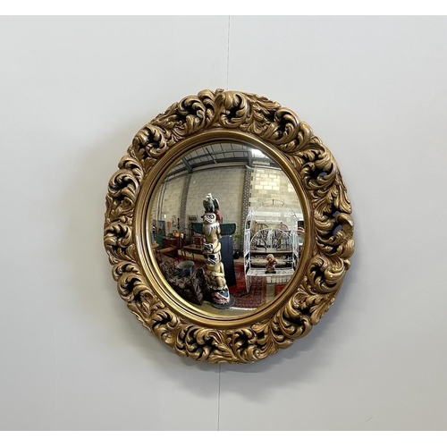 1094 - A circular gilt composition convex wall mirror, diameter 51cm