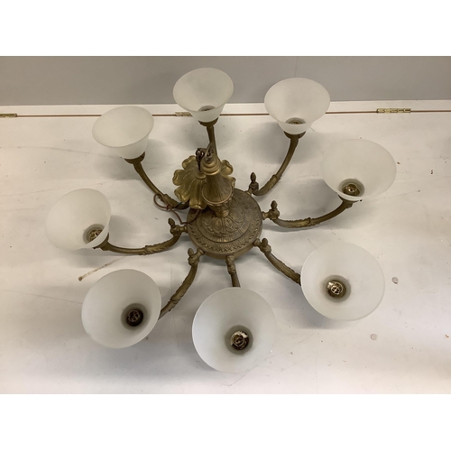 1101 - A brass eight branch chandelier with shades, width 42cm