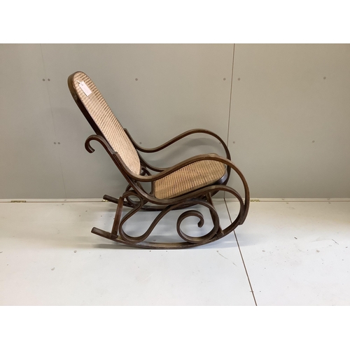 1103 - A caned beech bentwood rocking chair, width 49cm, depth 72cm, height 108cm