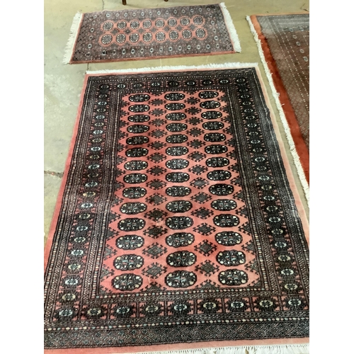 1105 - Two Bokhara peach ground rugs, larger 178 x 124cm