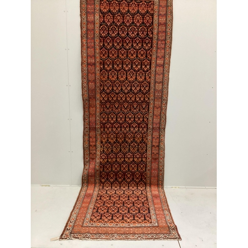 1115 - An Afshar blue ground runner woven with rows of floral devices, 354cm x 107cm