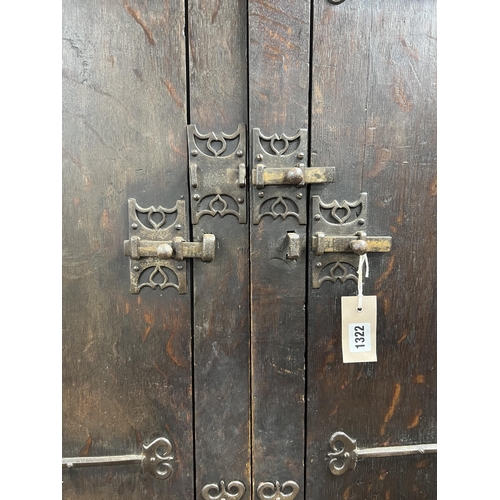 1134 - A pair of 16th century German or Netherlandish oak and wrought iron strapwork window shutters, later... 