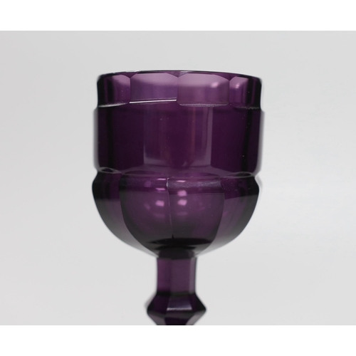 1281 - A Bohemian amethyst goblet, seemingly cut from a single piece of glass in a facetted form with a kno... 