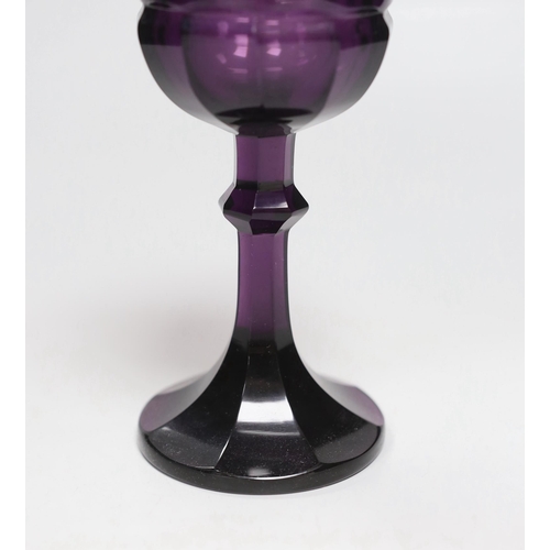 1281 - A Bohemian amethyst goblet, seemingly cut from a single piece of glass in a facetted form with a kno... 