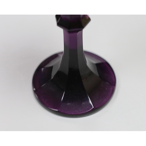 1281 - A Bohemian amethyst goblet, seemingly cut from a single piece of glass in a facetted form with a kno... 