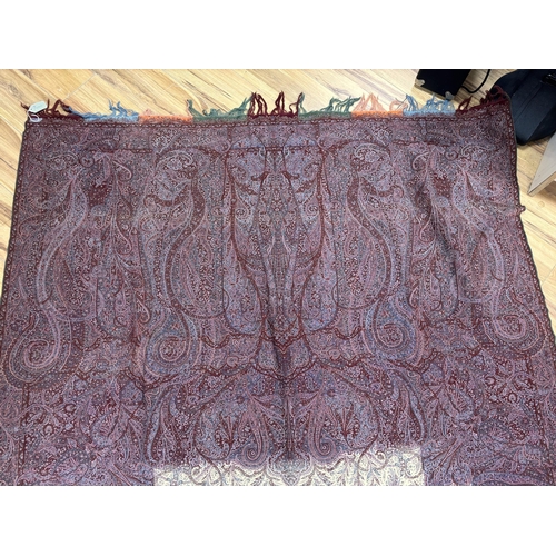 1300 - A late 19th century wool woven Paisley shawl with cream central cartouche (some damage)