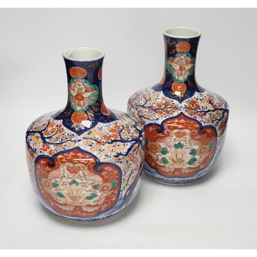 1308 - A pair of Japanese Imari vases, Meiji period, ink label to one base, 29cm high