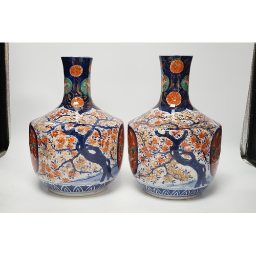 1308 - A pair of Japanese Imari vases, Meiji period, ink label to one base, 29cm high