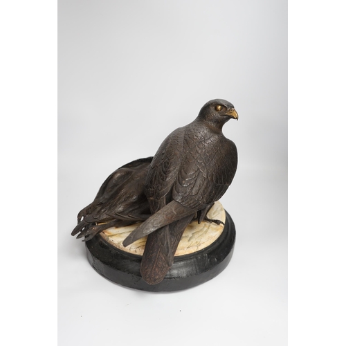 1315 - A limited edition bronze bird of prey with a kill, on a faux marble disc and painted wooden stand, 2... 